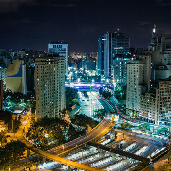 Building and streets at night with various lights displayed.